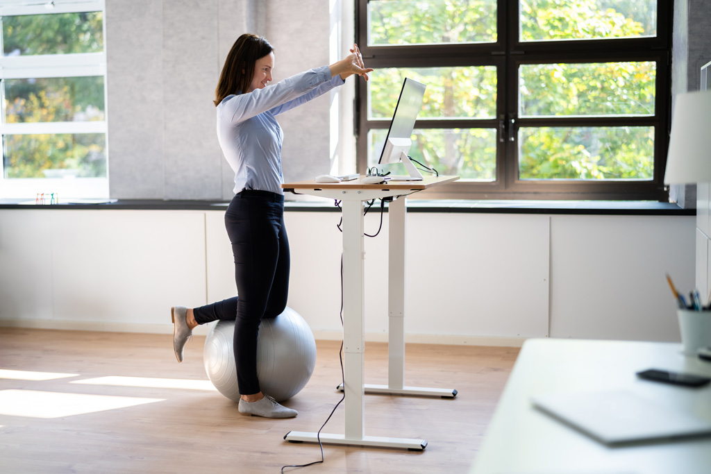 Worker Stretch Exercise At Stand Desk